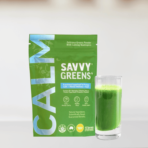Green smoothie powder package with a glass of green smoothie next to it.