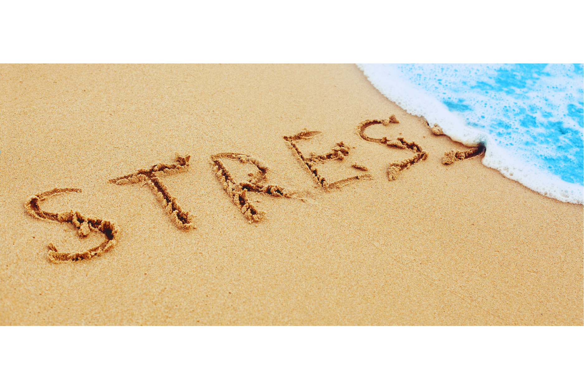 Stress written on sand being washed away by ocean wave