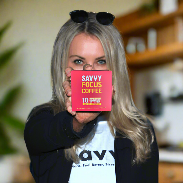 Woman holding a 'Savvy Focus Coffee' package